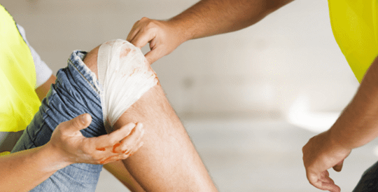 man holding an injured knee