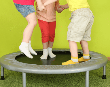 Young kids jumping on a trampoline