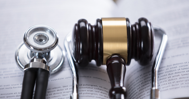 gavel and stethoscope on an open book