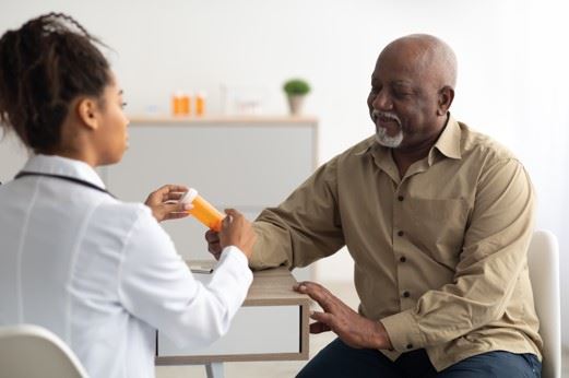 doctor giving prescription medications to patient